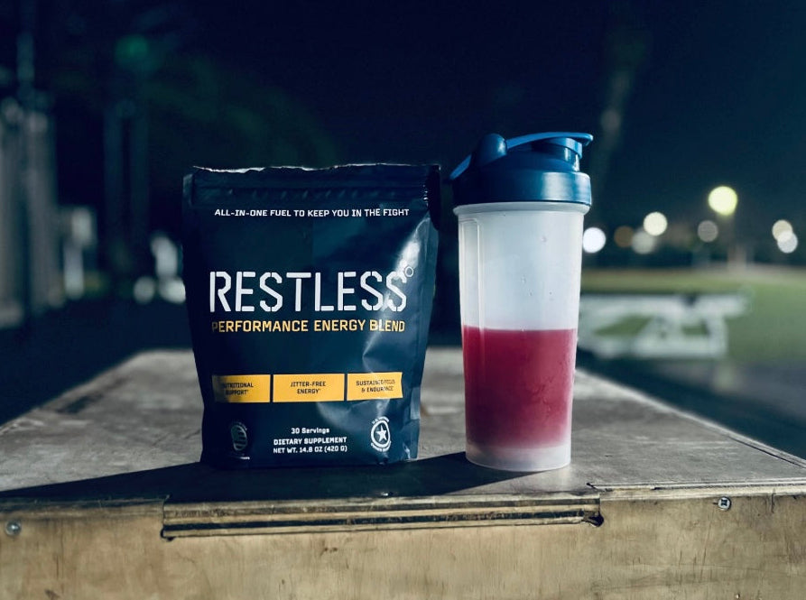 RESTLESS performance energy blend package with a shaker cup on a wooden surface at night.