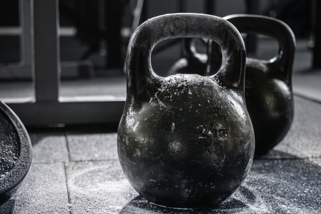 Black kettlebells in gym – symbolizing strength nutrients like vitamin D3, K2, and magnesium for bone and muscle recovery